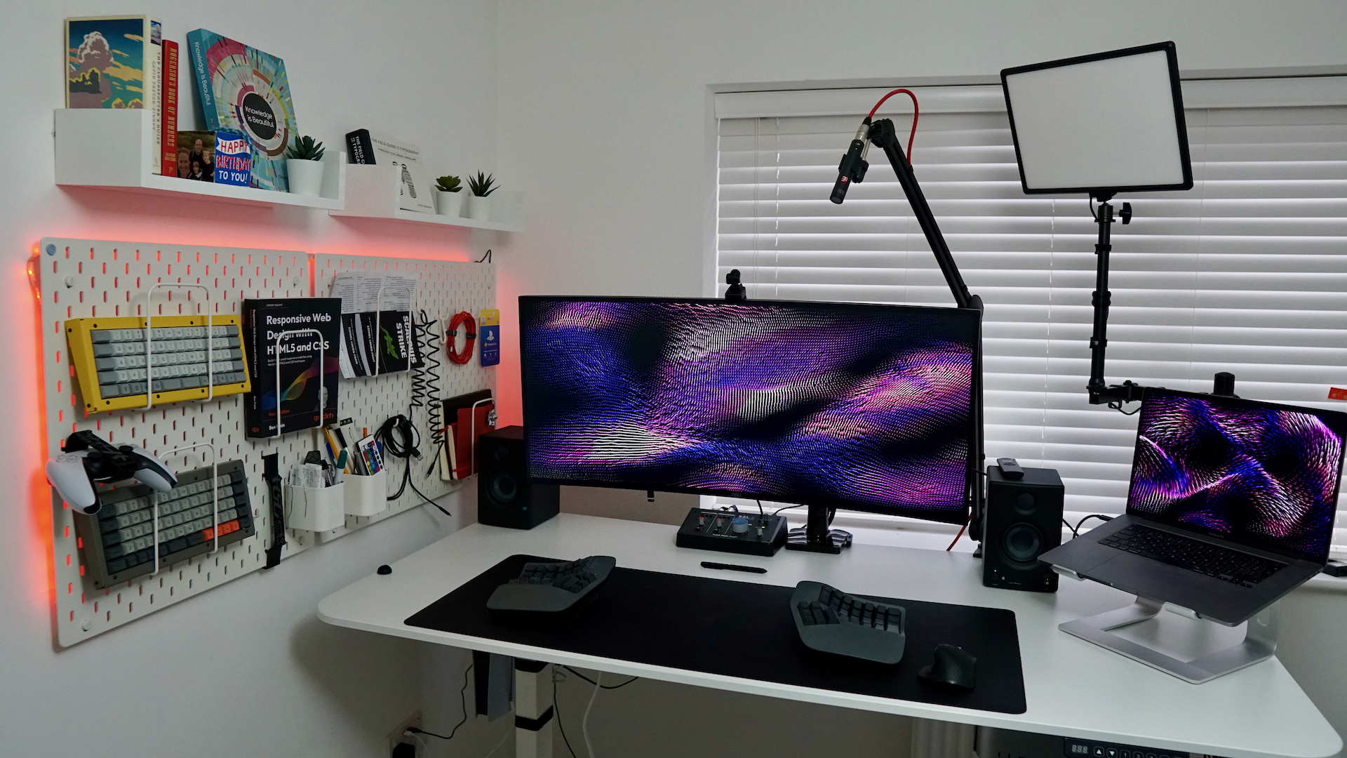 Desk setup with ultrawide monitor, deskmat and split keyboard